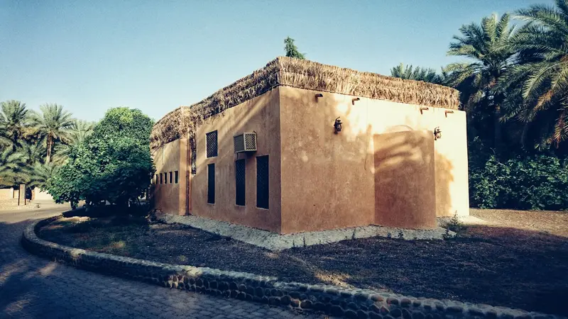 A traditional mud-brick building among the date palms of Al Ain Oasis