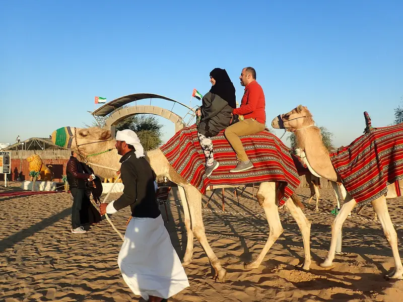 A camel ride during a desert safari tour